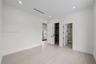 Neutral room with wood-finish flooring, recessed lighting, built-in closet shelving, and shaker-style interior doors