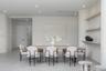 Interior space featuring smooth plaster wall finishes, curved structural columns, integrated wall shelving, recessed ceiling lighting, and solid-core 