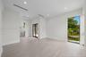 Neutral-toned wood-finish flooring, recessed lighting, floor-to-ceiling window, and sliding glass door