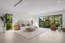 Spacious interior featuring light-toned wood-finish flooring, recessed lighting, full-height windows, and floor-to-ceiling sliding glass doors with da