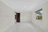 Interior space featuring large-format tile flooring, crown molding, recessed lighting, and a multi-panel wood door