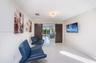 Polished tile flooring, custom wood-finish sliding barn doors with stainless steel hardware, and decorative flush-mount ceiling lighting