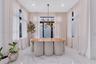 Large-format stone tile flooring, floor-to-ceiling drapery, multi-paned windows, and a multi-arm metallic chandelier