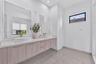 Floating vanity with wood-finish cabinetry, dual vessel sinks, solid-surface countertop, floor-to-ceiling mirrors, and rectangular transom window