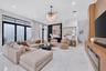 Living space featuring large-format tile flooring, floor-to-ceiling glass panel doors, a built-in wood-finish media console with an integrated firepla
