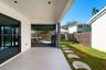 Covered patio featuring large-format porcelain tile flooring and recessed lighting, expanded by a secondary metal-framed outdoor structure with wood-f
