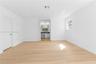 Interior space featuring wood-finish flooring, recessed lighting, and a single-pane window with white trim