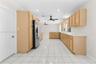 Kitchen featuring light-finish cabinetry, white countertops, ceramic tile flooring, recessed lighting, and dual ceiling fans