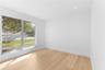 Bright interior space featuring wood-finish flooring, recessed lighting, and large horizontal sliding windows