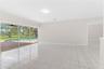Open-concept interior featuring oversized tile flooring, recessed ceiling lighting, and expansive floor-to-ceiling sliding glass doors leading to a sc