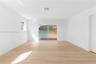 Bright interior featuring wood-finish flooring, recessed lighting, and sliding glass doors with access to an exterior screened enclosure