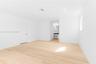 Interior room featuring light wood-finish flooring, recessed lighting, and crisp white wall finishes