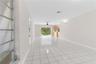 Interior space featuring large-format tile flooring, a ceiling fan, sliding glass doors, and built-in cabinetry