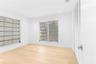 Bright interior featuring wood-finish flooring, recessed lighting, and louvered windows with horizontal blinds
