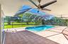 Screened-in lanai featuring a swimming pool, ceramic tile flooring, and ceiling fans