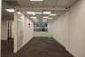 Interior office space featuring floor-to-ceiling glass panel walls, a glass swing door with metal hardware, drop ceiling with recessed panel lighting,