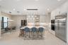 Kitchen featuring flat-panel cabinetry, a central island with a quartz countertop, professional-grade stainless steel appliances, a built-in wine refr