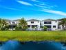 Waterfront property featuring a private swimming pool, screen-enclosed patio, and manicured lawn