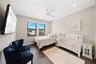 Neutral-toned room featuring wood-finish flooring, recessed lighting, and a ceiling fan