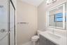 Bathroom featuring a glass-enclosed shower, integrated vanity with a rectangular sink, wall-mounted illuminated mirror, and polished chrome hardware
