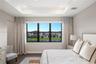 Tray ceiling with integrated recessed lighting and large windows featuring black frames and wood-finish flooring