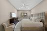 Neutral wall tones featuring a high ceiling with recessed lighting and a ceiling fan, complemented by windows with dark framing