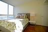 Floor-to-ceiling windows, wood-finish flooring, and neutral painted walls