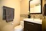 Modern vanity with a rectangular sink, espresso-finish cabinetry, mosaic tile backsplash, and a framed mirror