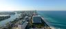 Aerial perspective featuring coastal shoreline, oceanfront geography, urban skyline, and inlet waterways