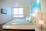 Wood-finish flooring, floor-to-ceiling windows, and wall-mounted television