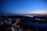 Elevated perspective featuring coastal waters, urban skyline, and bridge infrastructure
