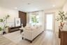 Living space featuring wood-finish flooring, vertical slat accent wall, recessed lighting, and a frosted glass-panel exterior door
