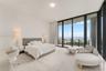 Floor-to-ceiling windows, sliding glass door, private balcony, neutral wall-to-wall carpeting, and recessed ceiling lighting