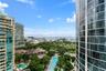 High-rise curtain wall construction, expansive floor-to-ceiling windows, and surrounding maritime landscape