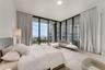 Floor-to-ceiling windows featuring wraparound panels, neutral carpeting, and access to a covered balcony