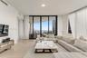 Living area featuring floor-to-ceiling glass sliding doors, neutral tile flooring, and integrated ceiling lighting