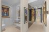 Hallway leading to guest bath, primary room & 2nd bedroom
