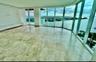 Expansive living area featuring floor-to-ceiling glass walls, large-format stone tile flooring, and integrated built-in cabinetry