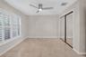 (FAN VIRTUALLY STAGED AS SIMILAR PIECE WILL BE INSTALLED)Large-format tile flooring, multi-panel plantation shutters, ceiling fan with integrated ligh