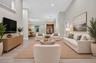 Spacious interior featuring vaulted ceilings, neutral wall tones, light wood-finish flooring, double front entry doors with glass panels, and multiple