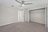 (FAN VIRTUALLY STAGED AS SIMILAR PIECE WILL BE INSTALLED) Neutral-toned interior space featuring neutral wall-to-wall carpeting, a satin-nickel finish