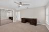 (FAN VIRTUALLY STAGED AS SIMILAR PIECE WILL BE INSTALLED) Bedroom featuring neutral carpet, mirrored sliding closet doors, a ceiling fan with integrat