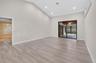 Vaulted ceiling featuring recessed lighting, wood-finish flooring, and sliding glass doors