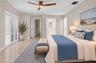 Neutral interior featuring polished stone flooring, three-blade ceiling fan with integrated lighting, and white plantation shutters