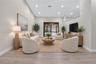 Living area featuring high vaulted ceilings, recessed lighting, wood-finish flooring, and black-framed sliding glass doors