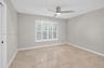 (FAN VIRTUALLY STAGED AS SIMILAR PIECE WILL BE INSTALLED)Neutral interior featuring large-format tile flooring, crisp neutral wall paint, white planta