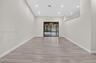 Open interior featuring high ceilings, recessed lighting, wood-finish flooring, and sliding glass doors