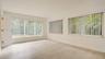 Interior space featuring wood-finish flooring, multi-pane windows with vertical blinds, and a paneled entry door