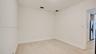 Interior space featuring wood-finish tile flooring and neutral wall paint