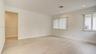 Interior space featuring light-toned wood-finish flooring, recessed lighting, and dual windows with vertical blinds